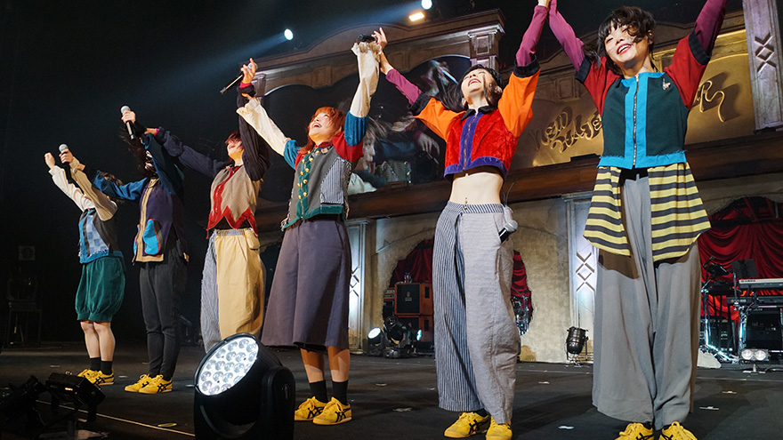 BiSH girl members making a celebration on stage