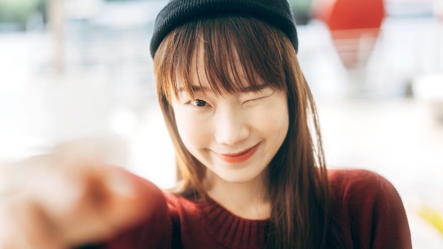 A Korean k-pop fangirl is smiling